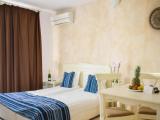 Standard Quadruple room with balcony and with partial sea view