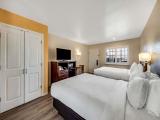 Efficiency Quadruple Room with Two Queen Beds and Sofa Bed - Non Smoking